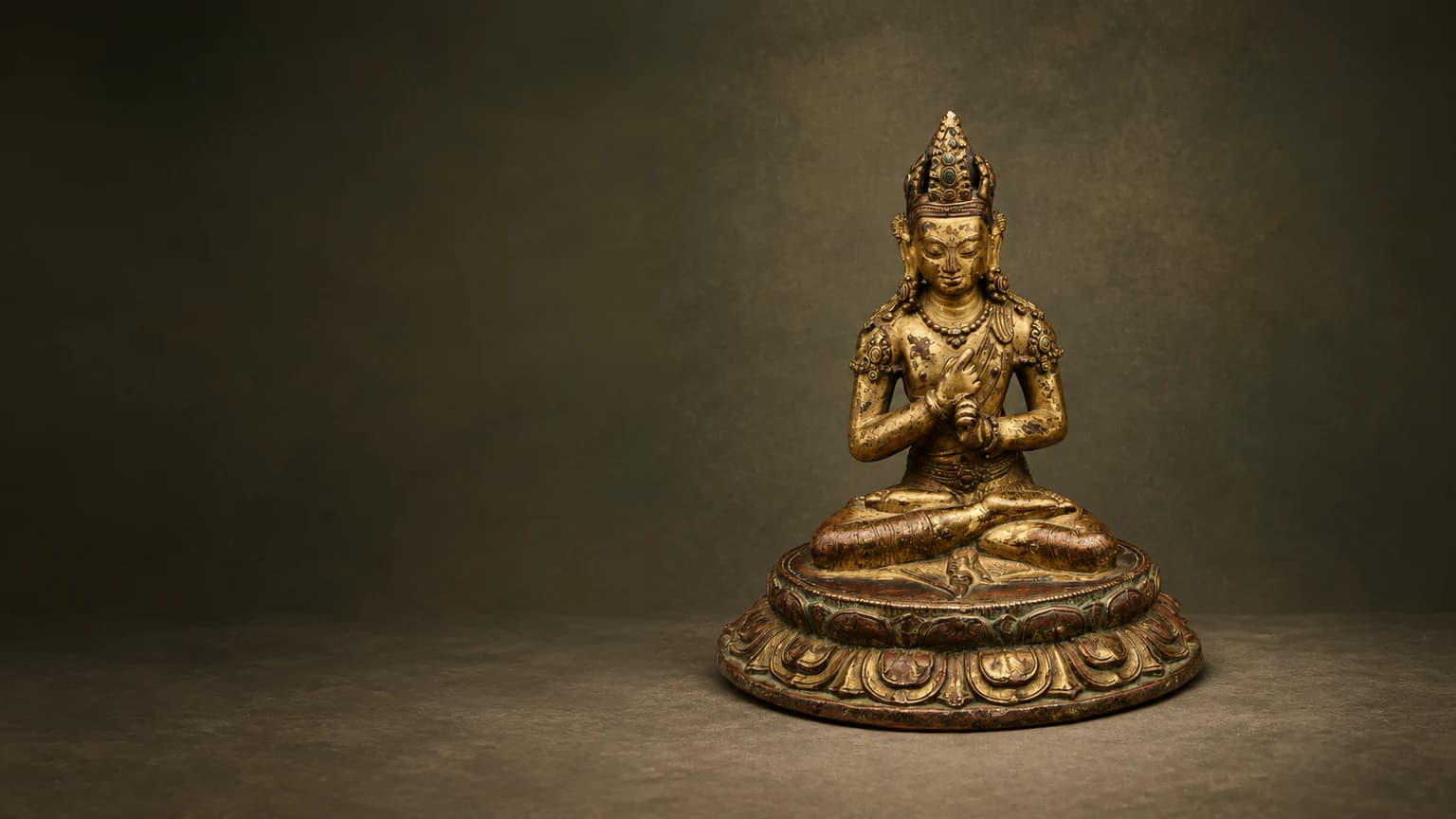The intricate metalwork and finish of a Buddhist statue